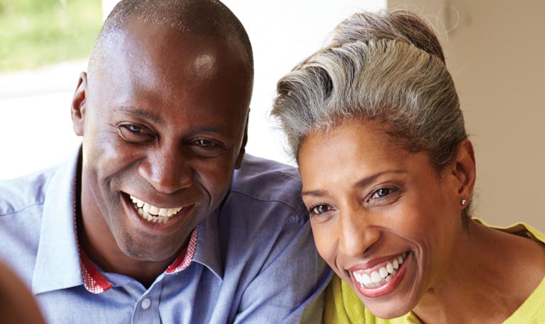 An older African American couple embrace the power of planning.