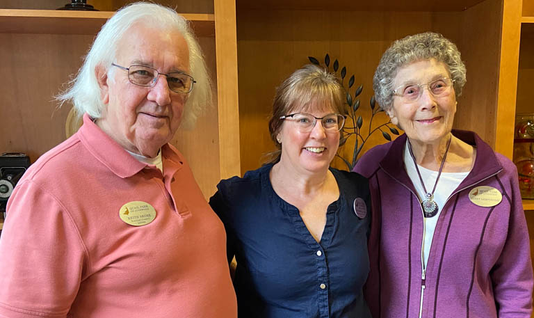Sue Rowell stands between two Quail Park of Lynnwood Residents who helped her gain a positive view of the aging process.